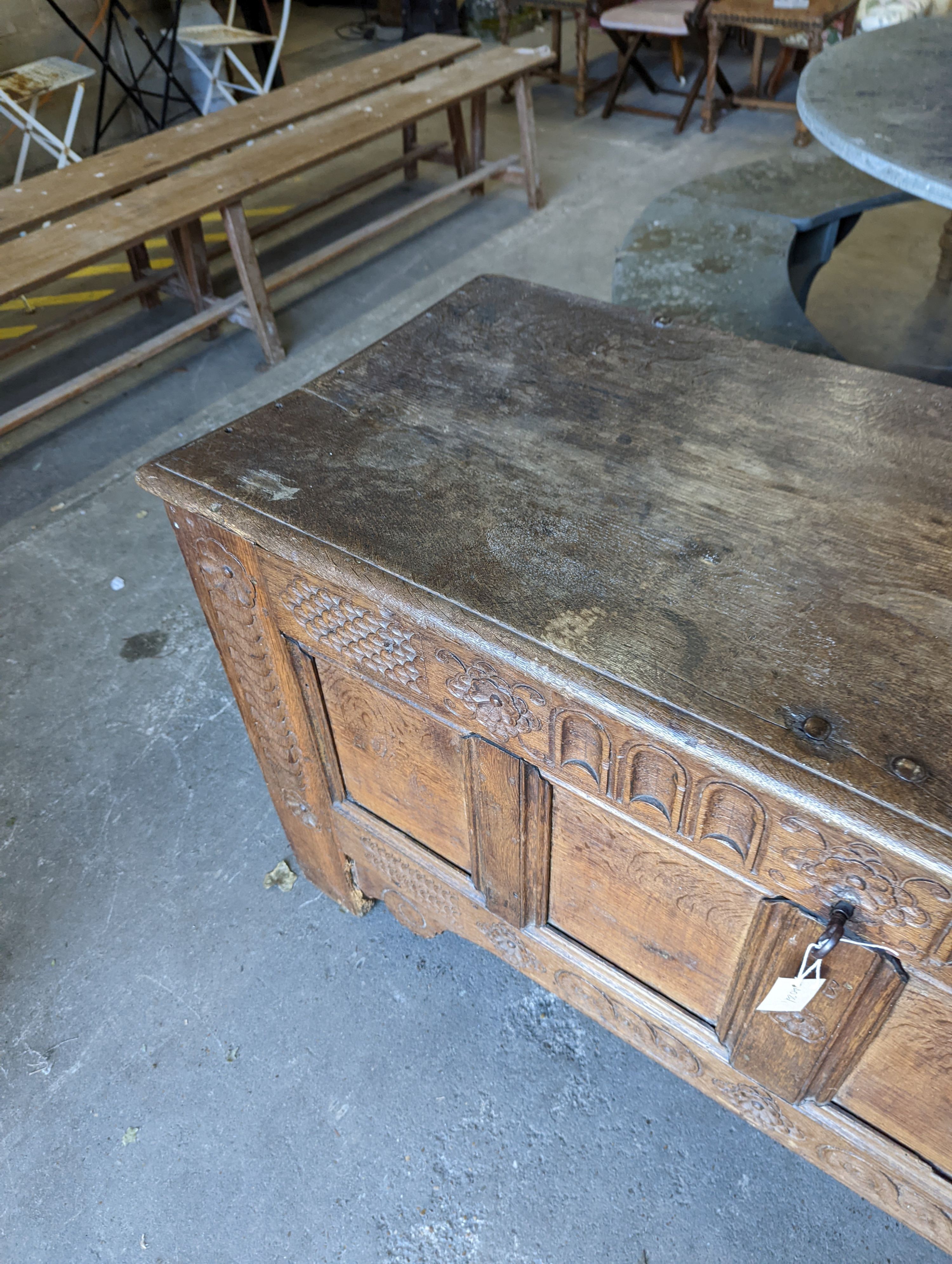 A large 17th century oak panelled coffer, length 147cm, depth 58cm, height 74cm